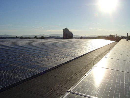 Blick über die 5 MW Dachphotovoltaikanlage auf dem Dach der TTS-Spedition in Bürstadt (Foto: Author: Micha Jost / commons.wikimedia.org / keine Änderungen / CC BY-SA 3.0) Blick über die 5 MW Dachphotovoltaikanlage auf dem Dach der TTS-Spedition in Bürstadt (Foto: Author: Micha Jost / commons.wikimedia.org / keine Änderungen / CC BY-SA 3.0)